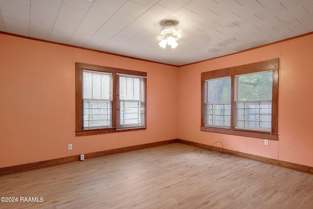 unfurnished room featuring ornamental molding, light wood-type flooring, and ceiling fan