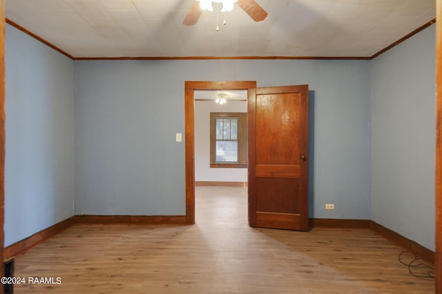 unfurnished room featuring ornamental molding, ceiling fan, and light hardwood / wood-style flooring