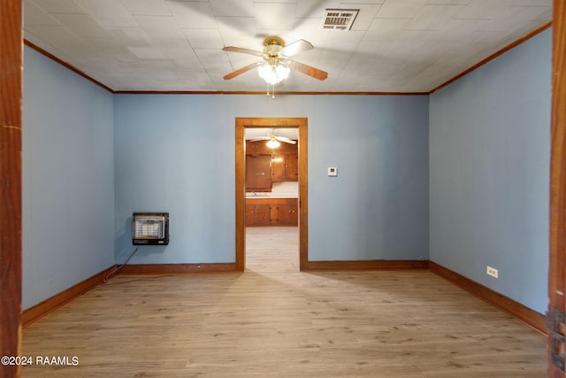 unfurnished room with ceiling fan, heating unit, crown molding, and light hardwood / wood-style floors