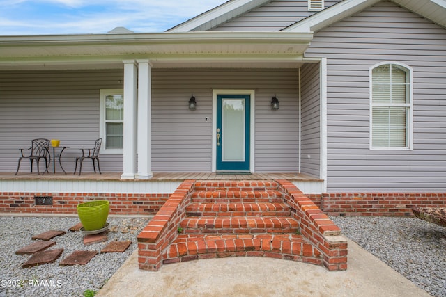 doorway to property featuring covered porch