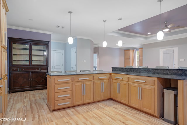 kitchen with ceiling fan, decorative light fixtures, light wood-type flooring, and ornamental molding