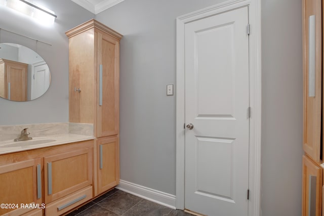 bathroom with ornamental molding, vanity, and tile patterned floors