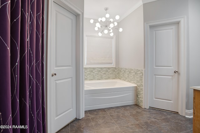 bathroom featuring vanity, a tub, an inviting chandelier, crown molding, and tile patterned flooring