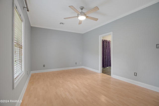 spare room with light hardwood / wood-style flooring, ceiling fan, and crown molding