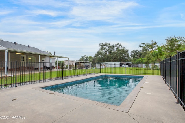 view of swimming pool with a patio and a yard