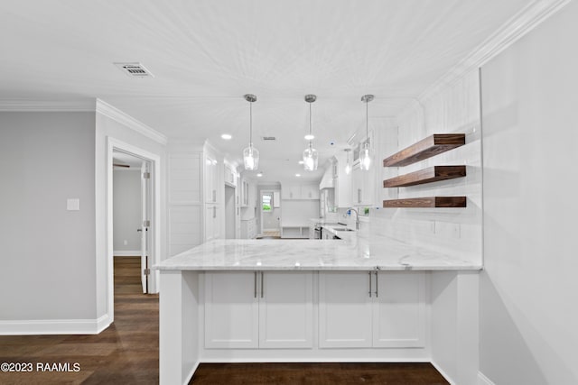 kitchen with hanging light fixtures, white cabinets, kitchen peninsula, dark hardwood / wood-style flooring, and sink