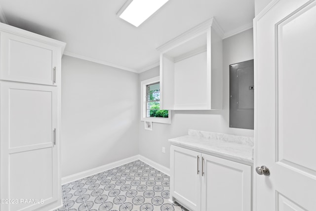 clothes washing area featuring crown molding and electric panel