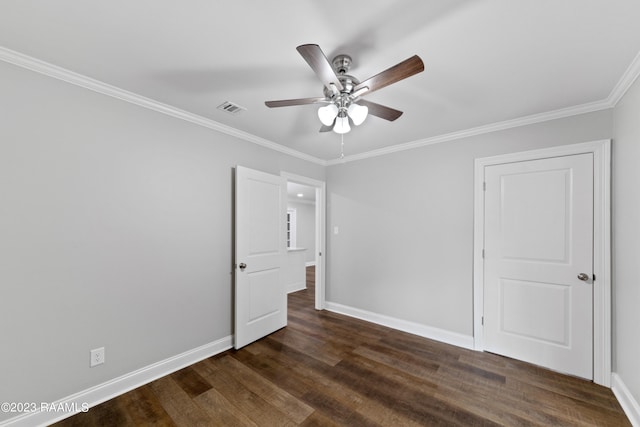 empty room with ceiling fan, crown molding, and dark hardwood / wood-style flooring