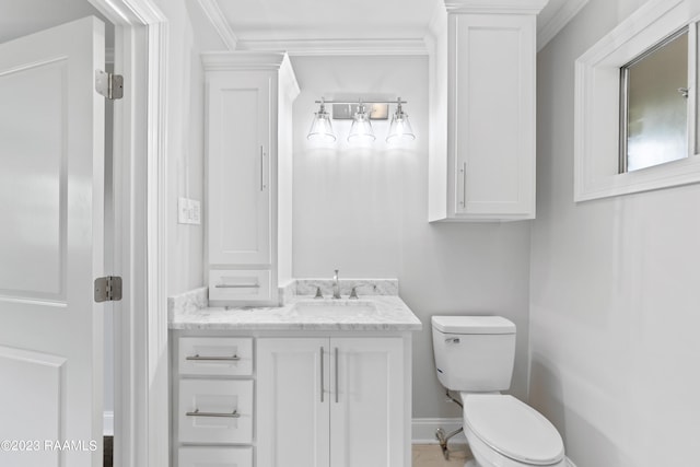 bathroom with vanity, crown molding, and toilet