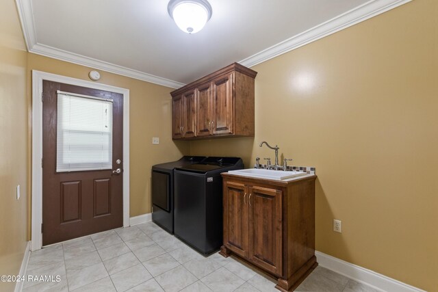 laundry room with crown molding, sink, and washing machine and clothes dryer