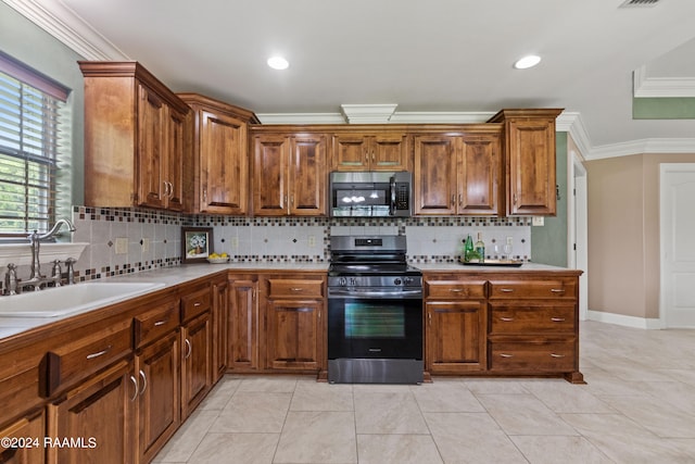 kitchen with tasteful backsplash, sink, appliances with stainless steel finishes, light tile patterned floors, and ornamental molding