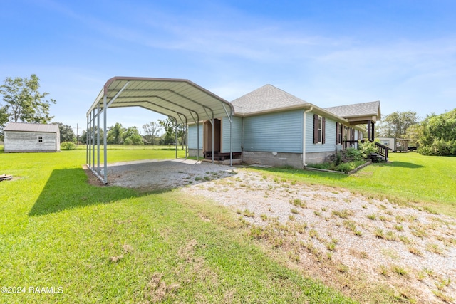 back of property with a yard and a carport