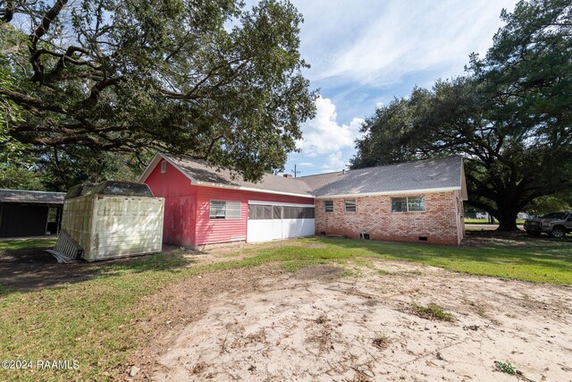 exterior space featuring a lawn and a storage shed