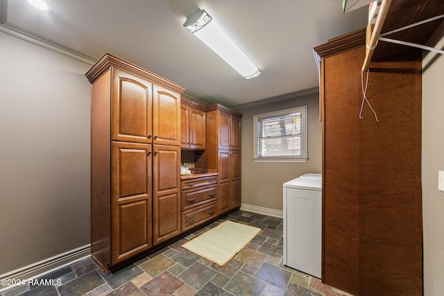 laundry area featuring washer / clothes dryer, cabinets, and ornamental molding