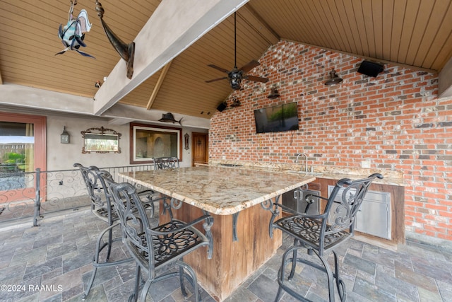 view of patio featuring ceiling fan and a wet bar