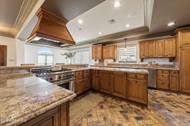 kitchen with appliances with stainless steel finishes, crown molding, premium range hood, and light stone counters