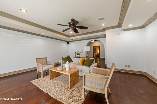 living room featuring ornamental molding, ceiling fan, and dark hardwood / wood-style floors