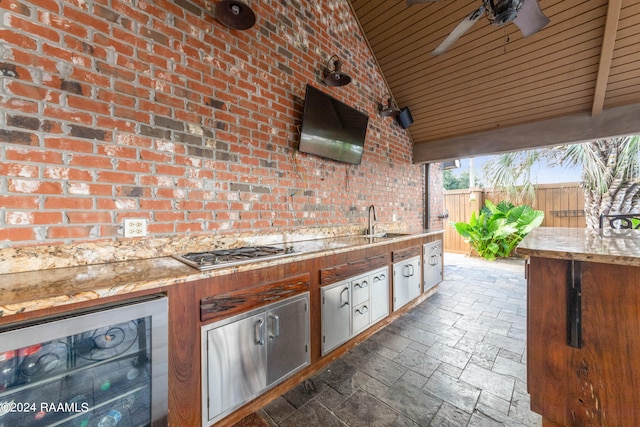 view of patio featuring ceiling fan, wine cooler, and sink