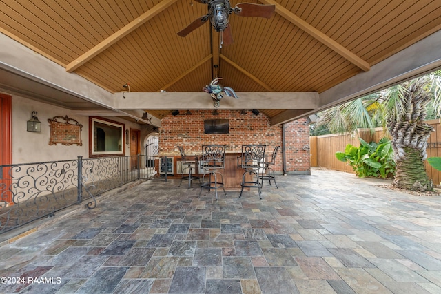 view of patio featuring an outdoor bar and ceiling fan