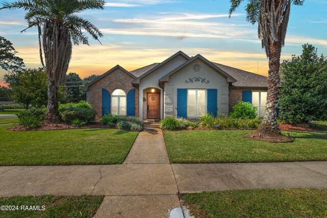 view of front of house with a lawn