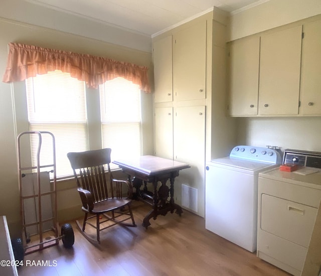 laundry room featuring cabinets, separate washer and dryer, dark wood-type flooring, and crown molding