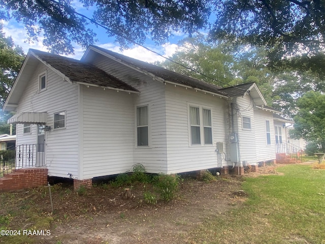 view of home's exterior with a yard