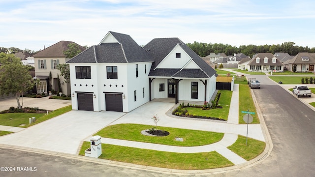 view of front of property featuring a garage and a front lawn