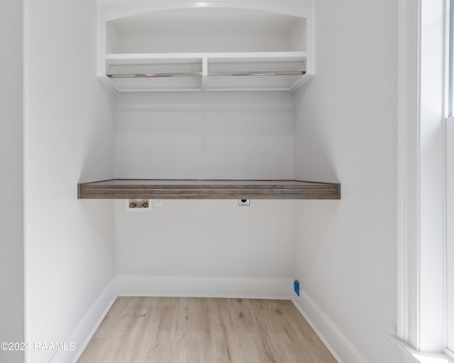 clothes washing area featuring hookup for a washing machine and light hardwood / wood-style floors