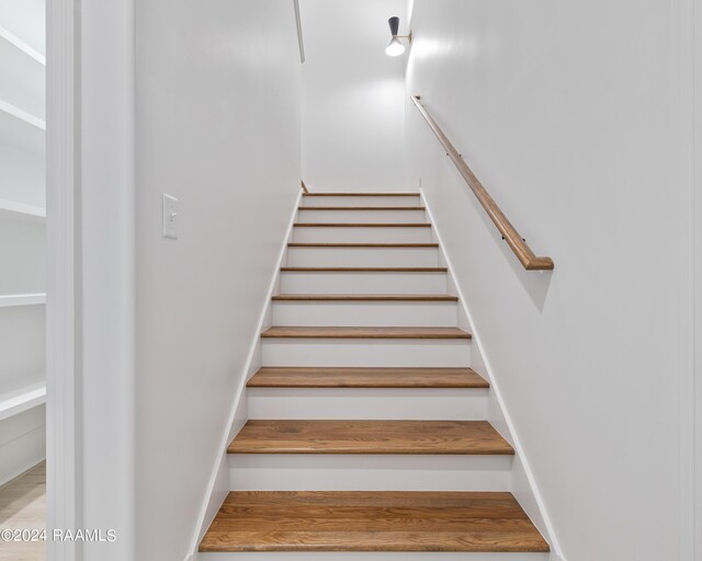 stairway with wood-type flooring