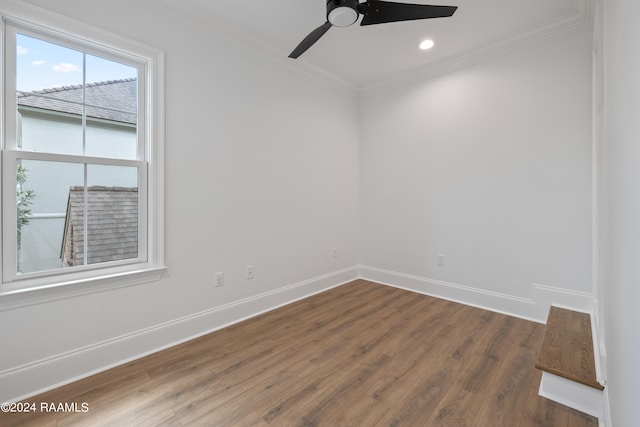 empty room with dark hardwood / wood-style floors, crown molding, and ceiling fan