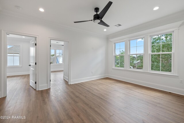 spare room with crown molding, ceiling fan, and hardwood / wood-style floors