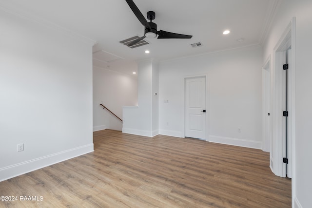 spare room with ornamental molding, light hardwood / wood-style flooring, and ceiling fan