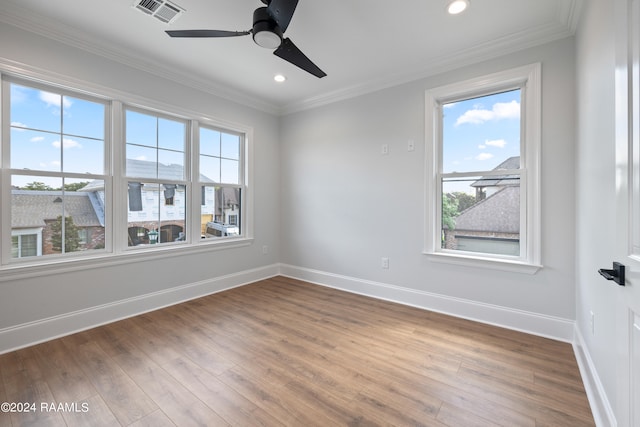 empty room with wood-type flooring, crown molding, and ceiling fan