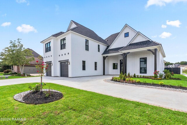 view of front of house featuring a front yard and a garage