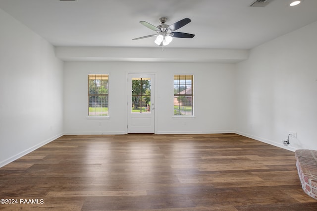 unfurnished room featuring ceiling fan and dark hardwood / wood-style flooring