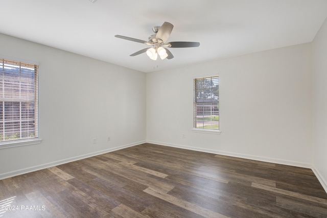 spare room with dark wood-type flooring and ceiling fan