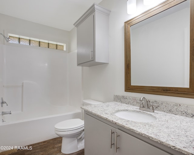 full bathroom with hardwood / wood-style floors, vanity, toilet, and bathtub / shower combination