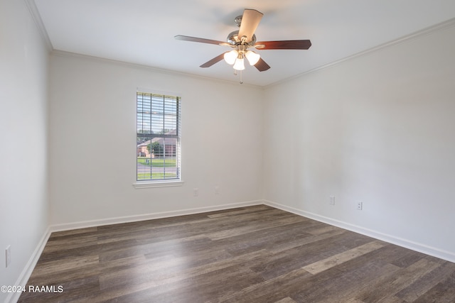 empty room with ornamental molding, ceiling fan, and dark hardwood / wood-style flooring