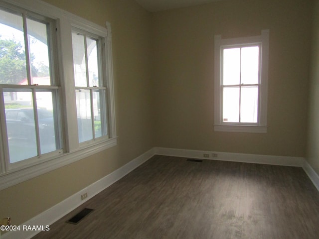 spare room with dark hardwood / wood-style flooring