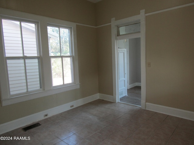 spare room with tile patterned flooring