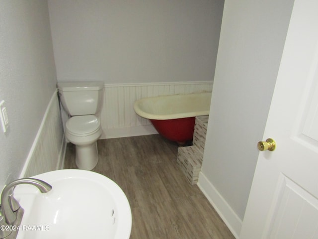 bathroom featuring hardwood / wood-style flooring, toilet, and sink