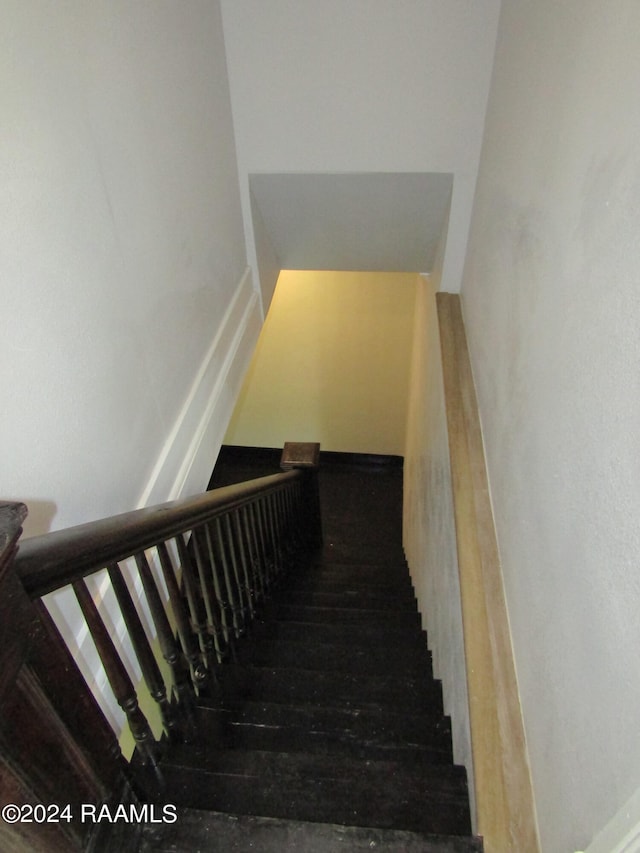 staircase with wood-type flooring