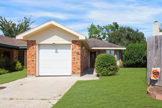 single story home featuring a garage and a front yard