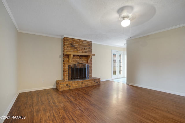 unfurnished living room with a fireplace, a textured ceiling, wood-type flooring, ceiling fan, and ornamental molding