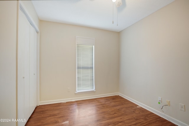 unfurnished bedroom featuring hardwood / wood-style flooring and a closet