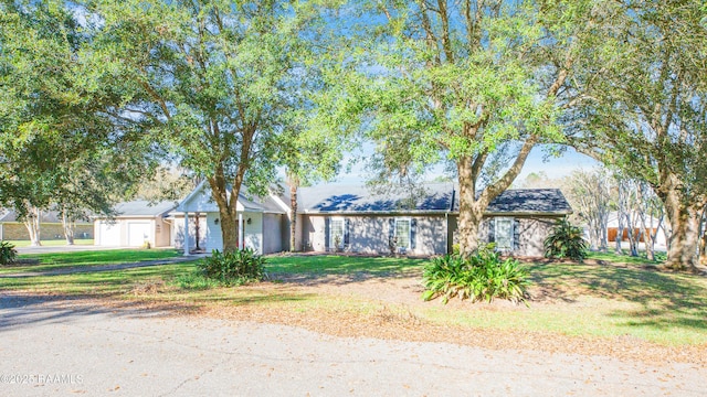 ranch-style house with a garage and a front yard