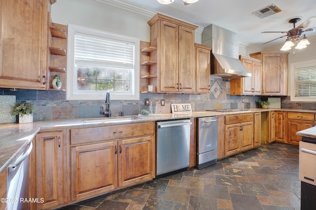 kitchen with ceiling fan, sink, stainless steel appliances, wall chimney range hood, and decorative backsplash