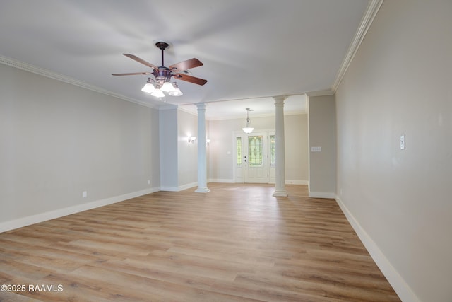 spare room with decorative columns, ceiling fan, light hardwood / wood-style flooring, and ornamental molding