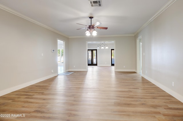 empty room featuring ceiling fan, light hardwood / wood-style floors, crown molding, and french doors