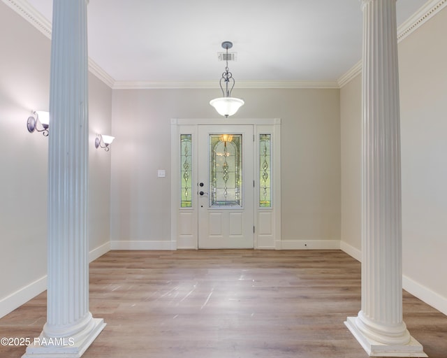 entryway with decorative columns, light hardwood / wood-style floors, and ornamental molding